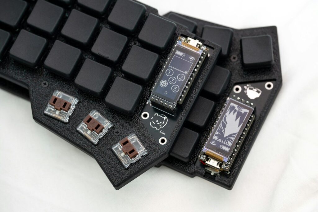A couple of electronic devices sitting on top of a keyboard
