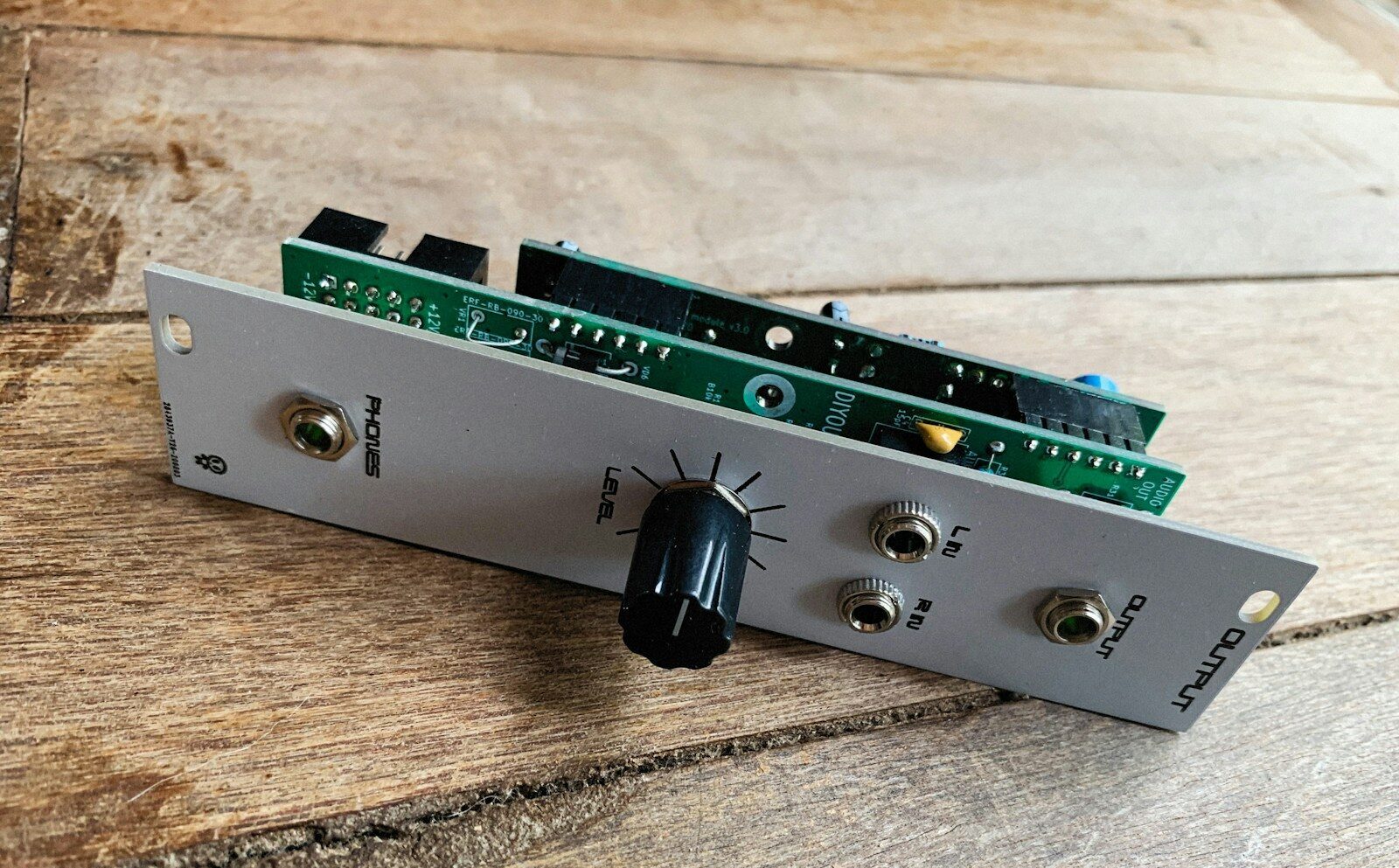 a close up of an electronic device on a wooden surface