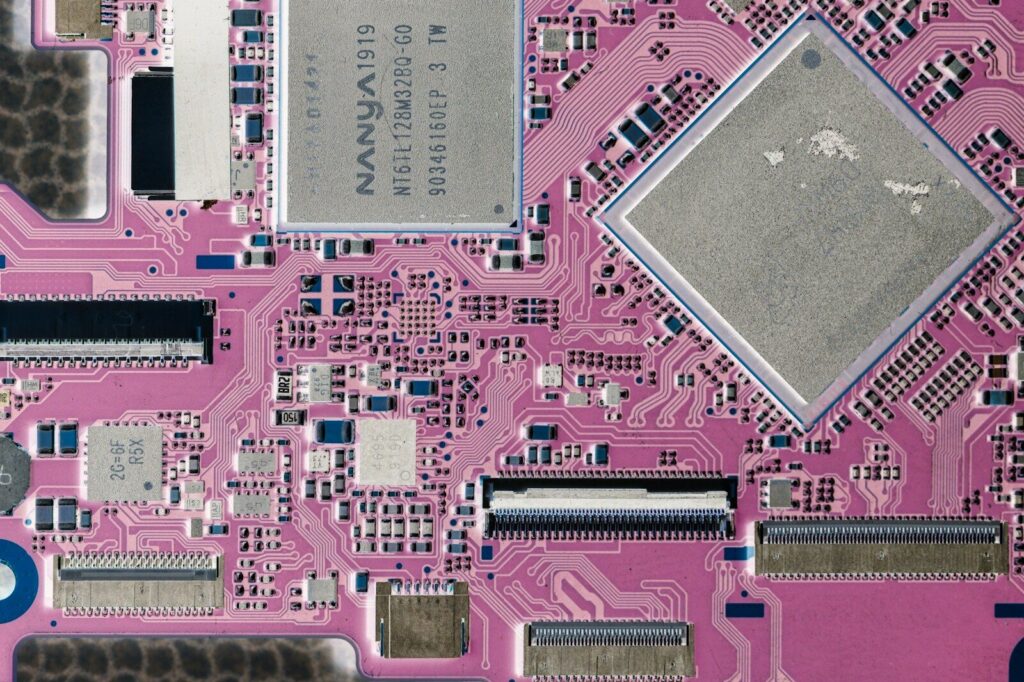 Close-up of a pink circuit board with electronic components