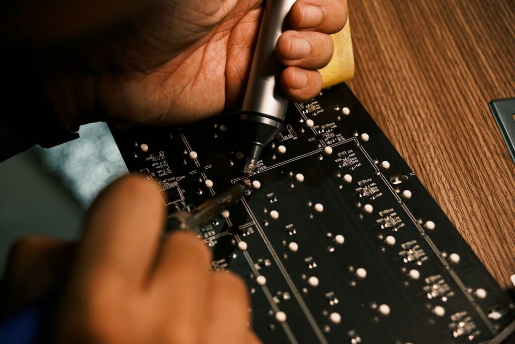 A person is working on a circuit board