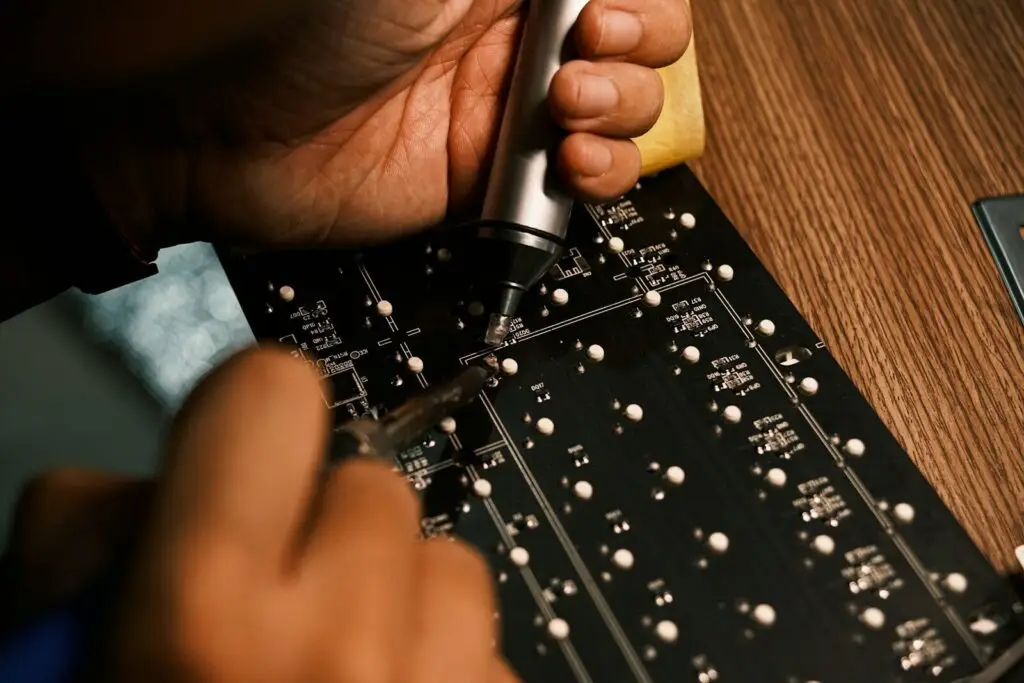 A person is working on a circuit board